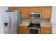 This kitchen features stainless steel appliances and complementary mosaic backsplash at 162 Autumn Falls Dr, Lake Wylie, SC 29710