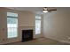 Bright living room boasts many windows and a cozy fireplace with mantle at 162 Autumn Falls Dr, Lake Wylie, SC 29710
