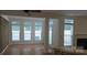 The living room has beautiful wood flooring and large bright windows at 162 Autumn Falls Dr, Lake Wylie, SC 29710
