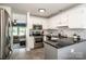 Well-lit kitchen features stainless steel appliances, granite countertops, and white cabinetry at 17406 Tuscany Ln, Cornelius, NC 28031