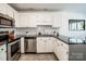 Bright kitchen with stainless steel appliances, subway tile backsplash, and ample counter space at 17406 Tuscany Ln, Cornelius, NC 28031