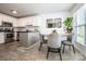 Eat-in kitchen with stainless appliances, subway tile, island, and natural light at 17406 Tuscany Ln, Cornelius, NC 28031