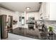Modern kitchen with stainless steel appliances, granite countertops, and stylish lighting at 17406 Tuscany Ln, Cornelius, NC 28031
