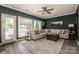 Inviting living room with neutral sofa, area rug, ceiling fan, and natural light at 17406 Tuscany Ln, Cornelius, NC 28031