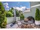 Outdoor patio featuring an outdoor table, a grill, and green surroundings at 17406 Tuscany Ln, Cornelius, NC 28031
