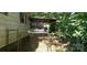 This carport is overgrown and has a chain-link fence at 202 N Dilling St, Kings Mountain, NC 28086
