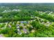 An aerial view shows 2103 Cantata Ct. in a well-maintained neighborhood surrounded by lush trees and landscaping at 2103 Cantata Ct, Matthews, NC 28105