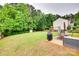 Spacious backyard with a well-manicured lawn, patio, playset, storage shed, and lush greenery at 2103 Cantata Ct, Matthews, NC 28105