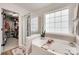 Luxurious bathroom with a soaking tub, separate shower, and walk-in closet for ultimate relaxation at 2103 Cantata Ct, Matthews, NC 28105