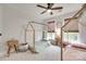 Bright bedroom featuring two house-frame beds, wood-look blinds, and a ceiling fan at 2103 Cantata Ct, Matthews, NC 28105