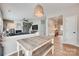 View of dining area with wood table and bench, open to the living room with a fireplace at 2103 Cantata Ct, Matthews, NC 28105