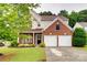 Charming two-story home featuring a brick facade, attached garage, and meticulously landscaped front yard at 2103 Cantata Ct, Matthews, NC 28105