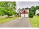Traditional two-story brick and siding home with a well-manicured lawn and a two-car garage at 2103 Cantata Ct, Matthews, NC 28105
