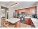 This is a warm kitchen with cherry wood cabinets, stainless steel appliances, and a center island at 2103 Cantata Ct, Matthews, NC 28105