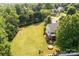 Aerial view of a home with a large, well-maintained yard, mature trees, and a screened porch, perfect for outdoor enjoyment at 2635 Mahogany Ln, Hickory, NC 28602
