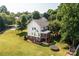 Aerial view of a home with a spacious backyard, mature trees, and a screened porch, offering a serene outdoor space at 2635 Mahogany Ln, Hickory, NC 28602