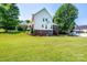Lush backyard featuring a spacious lawn, mature trees, and a screened porch, offering a serene outdoor retreat at 2635 Mahogany Ln, Hickory, NC 28602