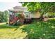 Expansive backyard featuring a large lawn, mature trees, a patio, and a screened porch, perfect for outdoor living at 2635 Mahogany Ln, Hickory, NC 28602