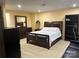 A spacious basement bedroom featuring a full-size bed and ample dark wood furniture at 2635 Mahogany Ln, Hickory, NC 28602