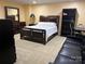 Finished basement bedroom featuring a bed, a dark wood dresser, and a workspace with a black chair at 2635 Mahogany Ln, Hickory, NC 28602