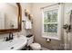 Charming bathroom with stylish sink, mirror, toilet, and natural light from the window at 2635 Mahogany Ln, Hickory, NC 28602