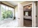A luxurious bathroom boasts a relaxing soaking tub with natural light and a view into the main bedroom at 2635 Mahogany Ln, Hickory, NC 28602