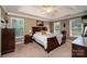 Comfortable bedroom with a tray ceiling, large window, and a well-crafted wood bed at 2635 Mahogany Ln, Hickory, NC 28602