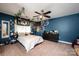 Well-decorated bedroom features a ceiling fan, white bedding, blue walls, and a dresser in neutral tones at 2635 Mahogany Ln, Hickory, NC 28602