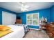 Cozy bedroom featuring blue walls, a window with blinds, a ceiling fan, and carpet flooring at 2635 Mahogany Ln, Hickory, NC 28602