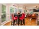 Bright breakfast nook with wooden floors, a square table, and windows overlooking the backyard at 2635 Mahogany Ln, Hickory, NC 28602