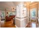 Hallway view featuring hardwood floors, architectural columns, and a glimpse into the bathroom at 2635 Mahogany Ln, Hickory, NC 28602