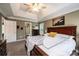 Comfortable main bedroom features tray ceilings, ceiling fan, carpet, and a walk-in closet through the bathroom at 2635 Mahogany Ln, Hickory, NC 28602