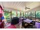 Spacious screened porch with dining table, seating, ceiling fan, and view of the surrounding greenery at 2635 Mahogany Ln, Hickory, NC 28602