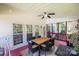 Inviting screened porch with dining table, comfortable seating, and a ceiling fan for a relaxing outdoor experience at 2635 Mahogany Ln, Hickory, NC 28602