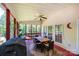 Large screened porch with a dining table, chairs, and a ceiling fan, perfect for outdoor relaxation and dining at 2635 Mahogany Ln, Hickory, NC 28602