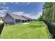 Spacious backyard with a green lawn and black fence at 3018 Trace Meadow Ct # 125, York, SC 29745