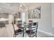 Open-concept dining area flows into a modern kitchen with sleek gray cabinetry and stainless steel appliances at 3018 Trace Meadow Ct # 125, York, SC 29745