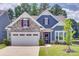 Charming home featuring stone accents, a two-car garage, and manicured lawn at 3018 Trace Meadow Ct # 125, York, SC 29745