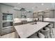 Modern kitchen features gray cabinetry, stainless appliances, and a large island with bar seating at 3018 Trace Meadow Ct # 125, York, SC 29745