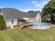 Spacious backyard showcasing an above ground pool, wooden deck, and outdoor seating area at 315 Talon Dr, Salisbury, NC 28147