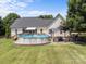 View of the backyard featuring an above ground pool, a patio with seating, and a large grassy area at 315 Talon Dr, Salisbury, NC 28147