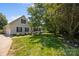 Attractive home featuring a lush lawn, mature trees, and a covered porch, perfect for relaxing outdoors at 315 Talon Dr, Salisbury, NC 28147