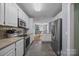 Bright kitchen featuring white cabinets, stainless steel appliances, and views to the adjacent dining area at 315 Talon Dr, Salisbury, NC 28147