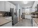 Kitchen boasts stainless steel appliances, ample counter space, and classic white cabinetry with eat-in nook at 315 Talon Dr, Salisbury, NC 28147