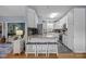 Kitchen with white cabinets, stainless steel appliances, breakfast bar, and view to the living area at 315 Talon Dr, Salisbury, NC 28147