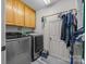 Laundry room with washer, dryer, storage cabinets, and tile flooring for easy cleanup at 315 Talon Dr, Salisbury, NC 28147