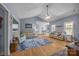 Spacious living room with vaulted ceiling, ceiling fan, and hardwood floors flowing into the dining room at 315 Talon Dr, Salisbury, NC 28147