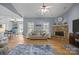 Open-concept living room flows into dining area, featuring a stone fireplace and lots of natural light at 315 Talon Dr, Salisbury, NC 28147