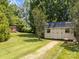 Charming outbuilding with double doors and brick pathway, offering practical storage space and curb appeal at 315 Talon Dr, Salisbury, NC 28147