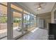 Bright sunroom with tiled floors, lots of windows, a ceiling fan, and access to the deck with a hot tub at 315 Talon Dr, Salisbury, NC 28147